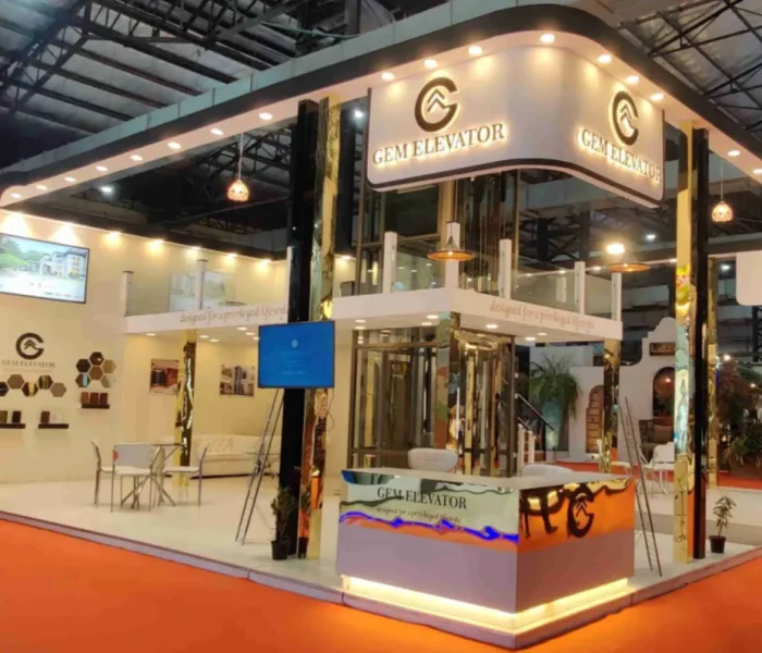 Custom GEM Elevator exhibition stall design featuring a sophisticated, multi-level architectural structure with integrated warm lighting and glass display elements.